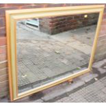 A large modern mirror or rectangular form partially gilt and painted moulded frame, 90cm x 115cm