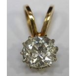 An 18ct gold solitaire diamond pendant claw set with a Victorian cut diamond weighing an estimated