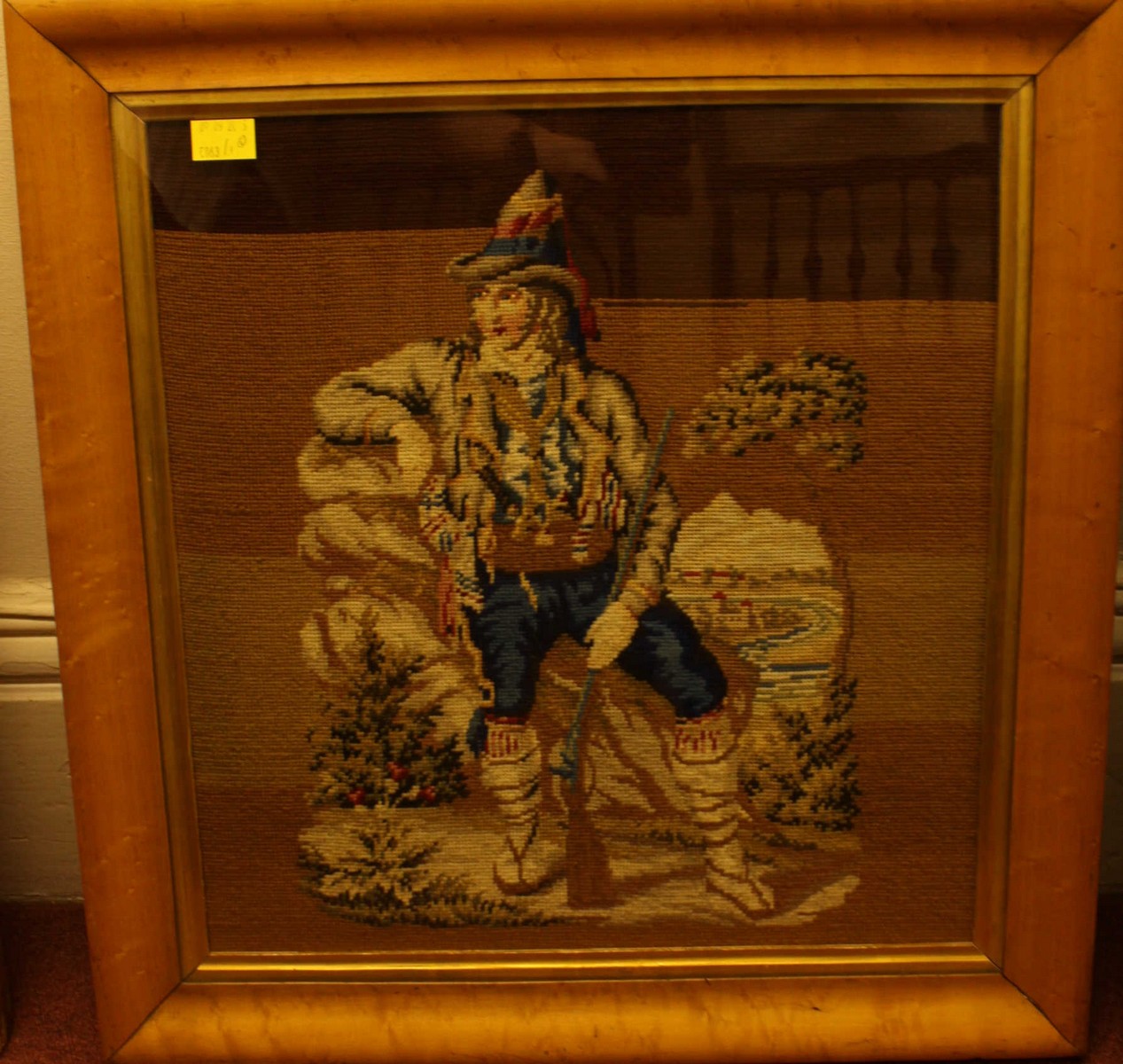 Two 19th century woolwork embroidered pictures of a huntsman, one with dogs, in birds eye maple