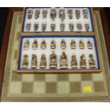 A boxed resin chess set, together with a large spare chess board.