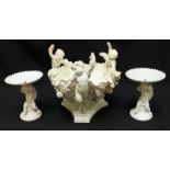 A large Victorian Moores style porcelain centrepiece, formed as three cherubs surrounding a shell