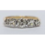 A ladies 18ct gold and platinum diamond ring, claw set with five graduated brilliant cut diamonds,