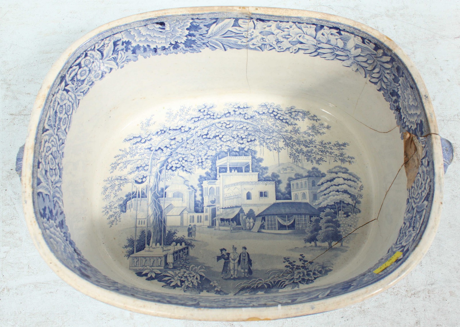 A large Victorian blue and white foot bath, cracked. 50 cm wide.