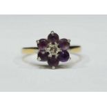 An 18ct gold, amethyst and diamond cluster ring, centrally set a round brilliant-cut diamond,