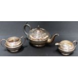 A George V silver three piece tea set, hallmarked Birmingham 1932, of globular form with banded