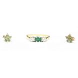 An 18ct gold, diamond and emerald ring, centrally set with an emerald-cut emerald flanked by two