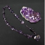 An amethyst necklace with alternating larger and smaller cut stones together with an amethyst