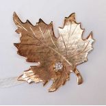 A 14K gold and diamond maple leaf brooch, stamped with makers mark: Bondboyd 14K. 6.6 grams.