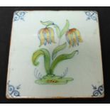 A Dutch Delft polychrome tile decorated with a tulip, 10cm x 10cm