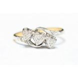 An 18ct gold, platinum and diamond ring, the top formed as a row of love-hearts illusion-set with