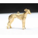 A 9ct gold solid-cast pendant modelled as a Lurcher dog, 10.3 grams