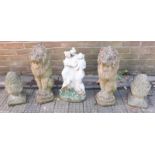 A pair of reconstituted stone seated lions, 55cm high, together with a pair of pineapple finals,