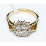 An 18ct gold diamond cluster ring, with angled split shoulders, claw set with four diamonds to the