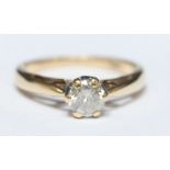 A 9ct gold solitaire diamond ring claw set with a round brilliant cut diamond, the diamond being I