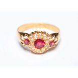 An early 20th century 18ct gold, diamond and ruby cluster ring, set with circular ruby surrounded by