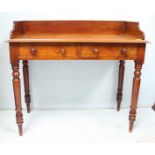 A Victorian mahogany writing table, the plain rectangular galleried top over two short drawers and