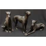 A set of three modern bronze greyhounds, in standing, seated and recumbent positions.