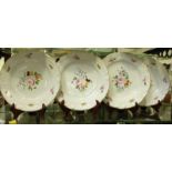 Four matching 18th century Derby porcelain plates, the shaped flange rims moulded with scrolling