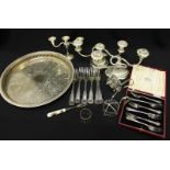 A box of silver plated items including a tray and candelabra.