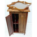 An early 20th century stained walnut gramophone stand-cabinet, with brushing slide above a pair of