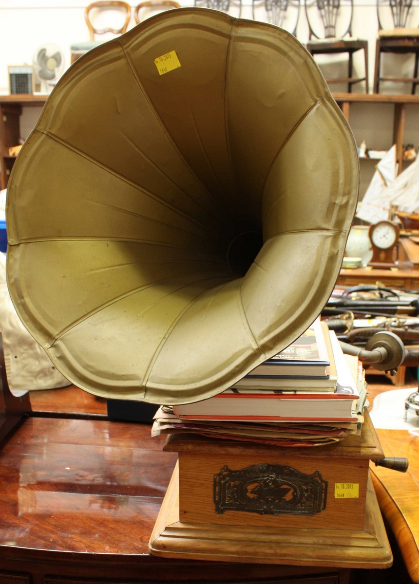 An early 20th century wind-up gramophone with horn, together with a quantity of records and books.
