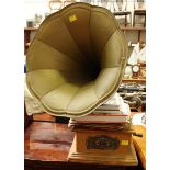 An early 20th century wind-up gramophone with horn, together with a quantity of records and books.