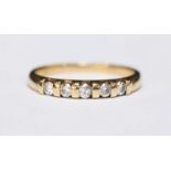 A 9ct gold five stone diamond ring bar set with 0.25 carats of round brilliant cut diamonds, total