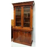 A large Victorian mahogany standing bookcase, the top with a pair of glazed doors enclosing