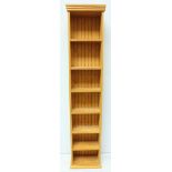 A tall modern pine bookcase with six shelves, 208 x 40cm