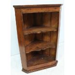 A stained oak hanging open corner cupboard with two shaped shelves. 109cm.