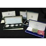 Five cased sets of silver proof coins.