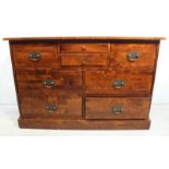 A large modern Laura Ashley hardwood chest of drawers, the plain top over two small central