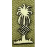 A WWII German DAK Afrika Korps palm tree label pin, in white enamel on white metal, the back with