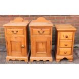 A pair of 20th Century pine bedside tables, both with single drawer above panelled cupboard and