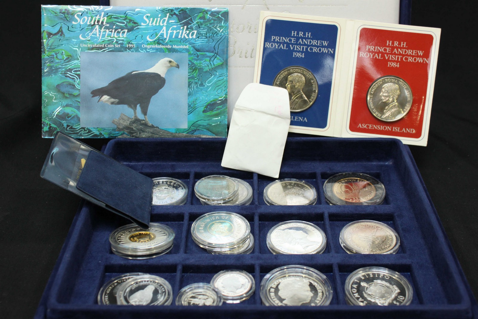 A collection of assorted silver proof coins in plastic cases.
