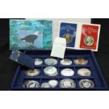 A collection of assorted silver proof coins in plastic cases.