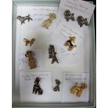 An unmarked gold poodle brooch weighing 4.3 grams, together with a silver example and nine costume