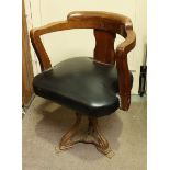 An early 20th century mahogany revolving tub chair, with padded seat, supported on a cast iron