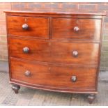 A Victorian mahogany bow- front chest of drawers with two short above two long drawers,  turned