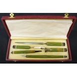 An Art Deco design desk writing set, comprising letter opener, pen, quill pen, quill cutter and a