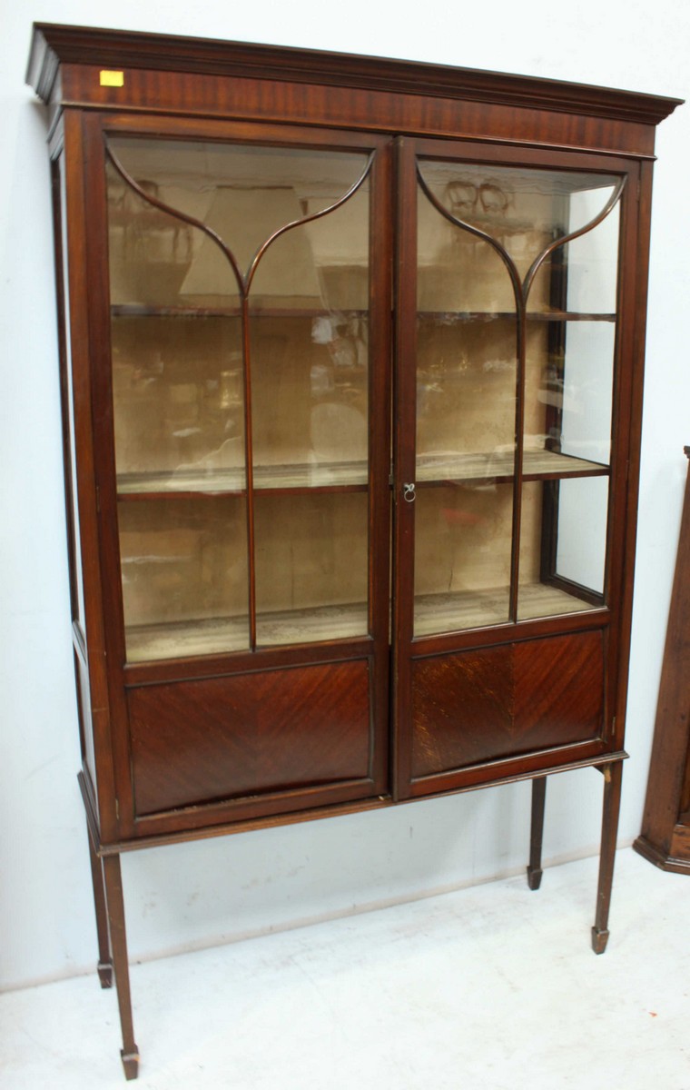 A large Edwardian mahogany two door display cabinet, with a pair of astragal glazed doors