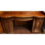 A large early Victorian mahogany serpentine fronted pedestal sideboard, with large central deep