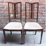 A pair of Edwardian mahogany inlaid dining chairs.