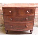 A Victorian mahogany bow- front chest of drawers with two short above two long drawers, turned pulls