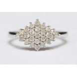 A 9ct gold cluster ring claw set with twenty five diamonds weighing a total of 0.50 carats, total