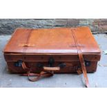 A large leather suitcase, with expanding top and strapwork. 126 cm wide.