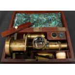 A Victorian brass student’s microscope, with lens and accessories in a fitted mahogany box.