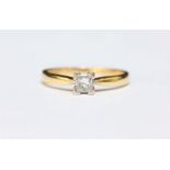 An 18ct gold solitaire diamond ring corner set with a princess cut diamond weighing 0.25 carats,