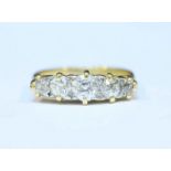 An 18ct gold graduated five stone diamond ring claw set with 0.75 carats of Victorian cut