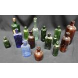 A collection of Victorian glass bottles, together with a set of bellows.